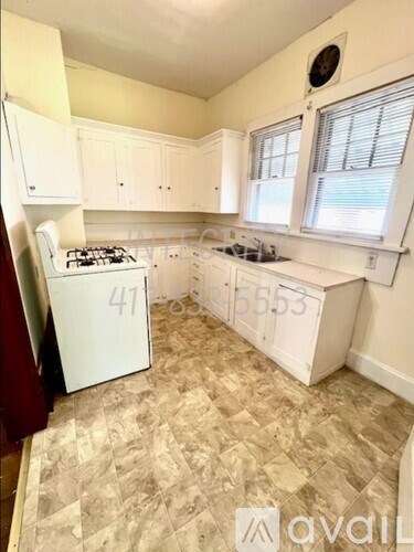 A kitchen with a white fridge and a white stove top.