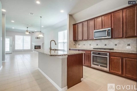 A kitchen with brown cabinets and a white island.