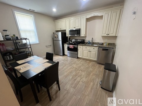 A kitchen with a table and chairs in the middle of the room.