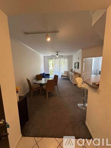 A living room with a dining table and chairs.