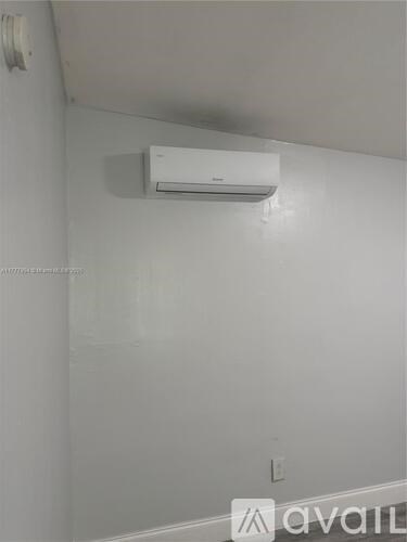 A wall-mounted air conditioner is installed on the wall.