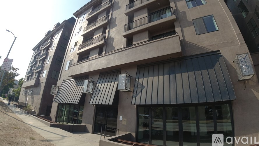 A modern building with a balcony and a sign that says "available".