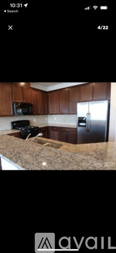 A kitchen with wooden cabinets and a granite countertop.