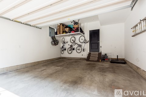 A garage with a bicycle wall decoration and a black door.