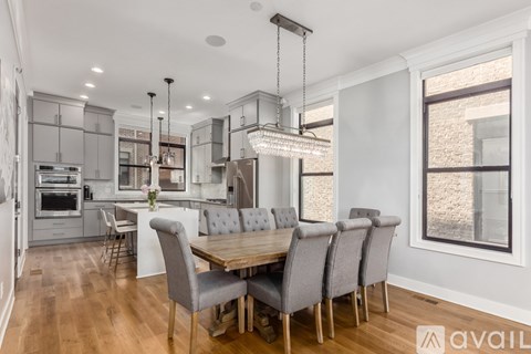 A modern kitchen with a dining table and chairs.