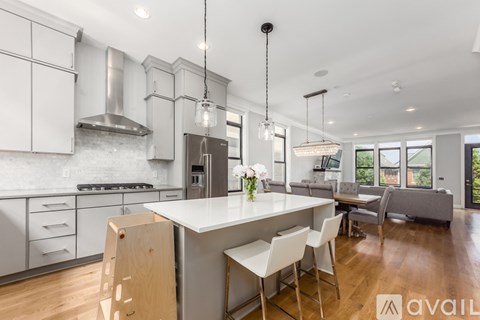 A modern kitchen with a large island and a dining area.