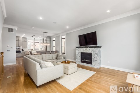 A living room with a white couch and a fireplace.