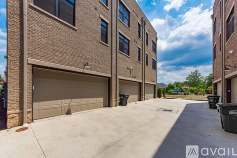 A row of garage doors in front of a building.