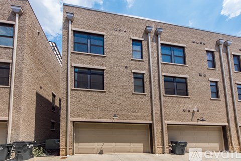A building with a beige facade and multiple garage doors.