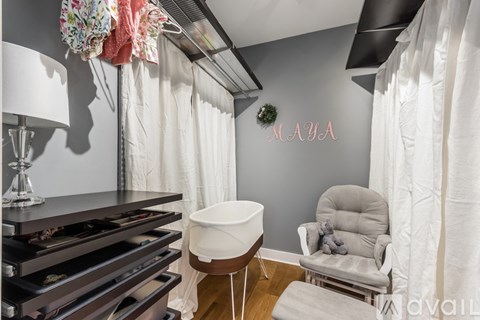 A room with a grey wall and a white chair.