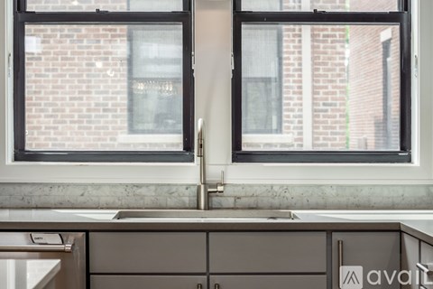 A kitchen with a window and sink.