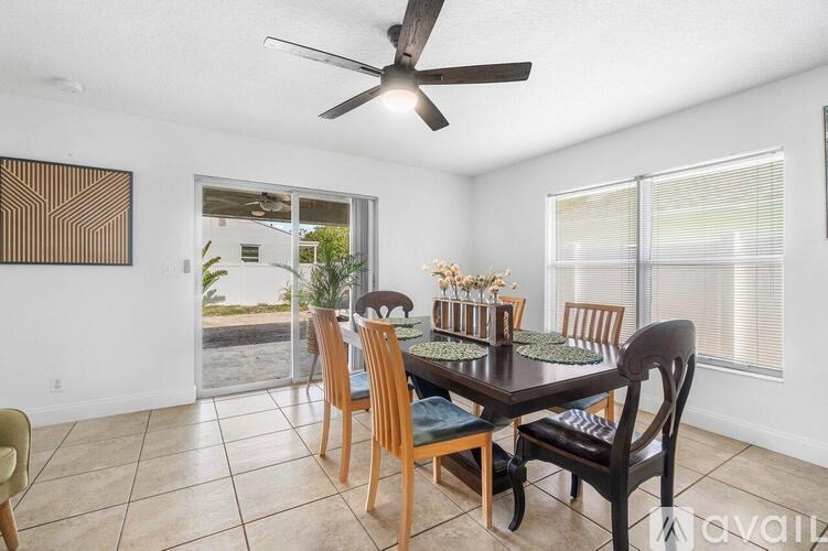 A dining room with a table set for six.