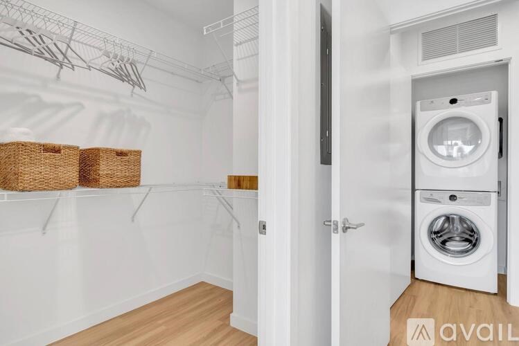 A laundry room with a washer and dryer stacked on top of each other.
