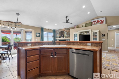 A kitchen with wooden cabinets and a stainless steel dishwasher.
