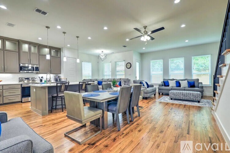 A spacious kitchen and dining area with wooden floors and modern furniture.