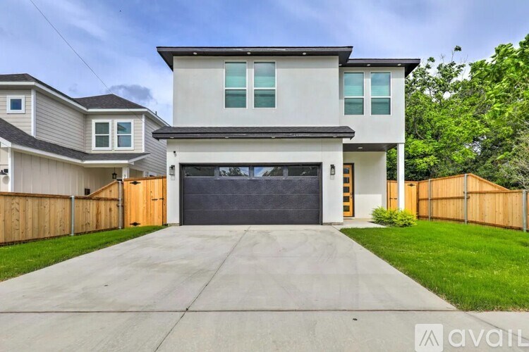 A modern house with a large garage is for sale.