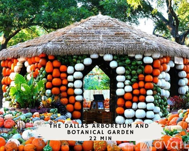 A pumpkin patch with a thatched roof and a sign that says "The Dallas Arboretum and Botanical Garden 22 min.".