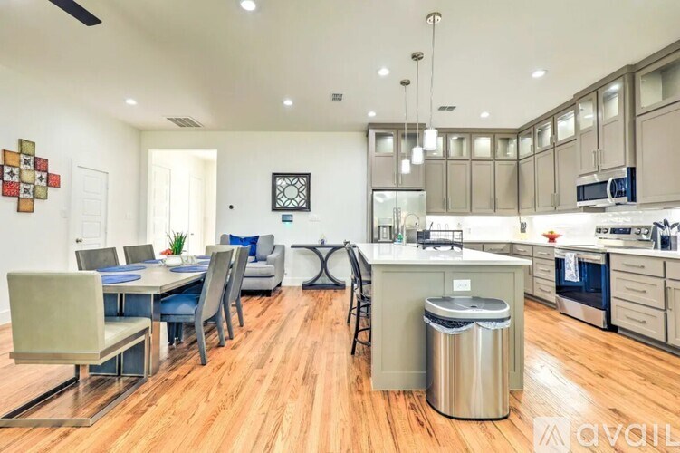 A modern kitchen with a dining table and chairs.