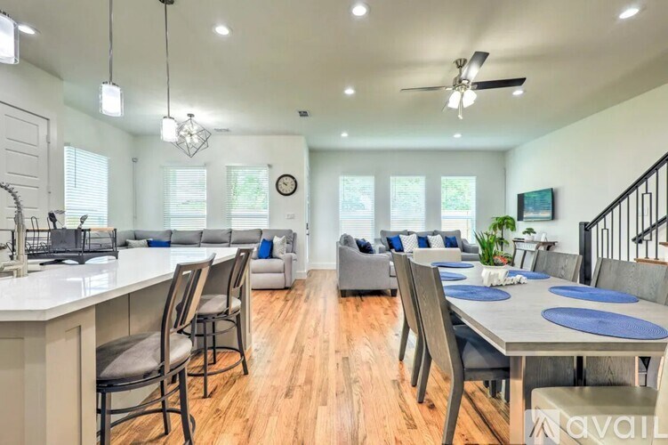 A modern kitchen with a dining area and a living room.
