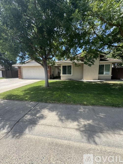 A house with a tree in front of it.