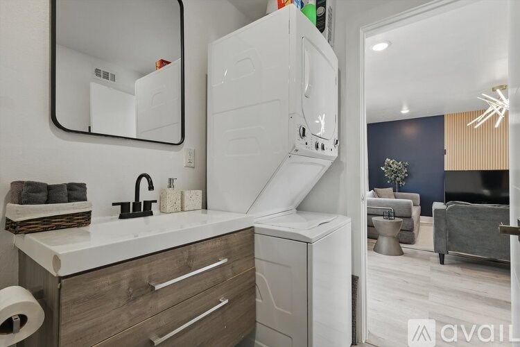 A modern kitchen with a white countertop and wooden drawers.