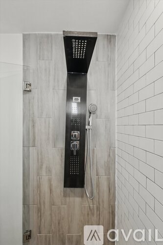 A modern bathroom with a black hand dryer mounted on the wall.