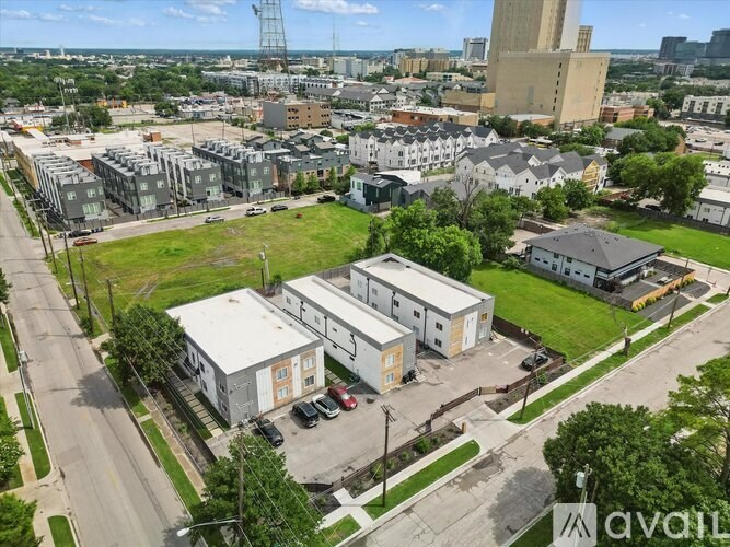 A bird's eye view of a city with buildings, roads, and cars.