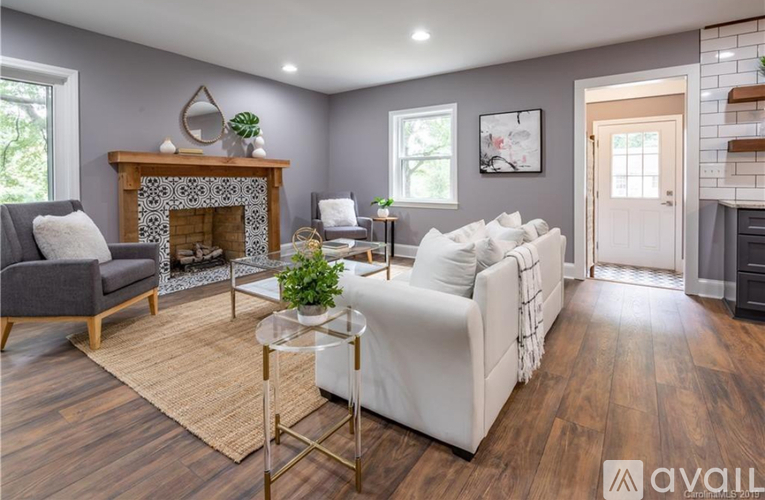 A living room with a fireplace and a white couch.