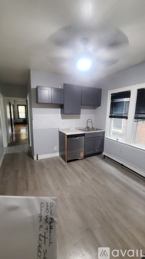 A kitchen with a sink and a window.