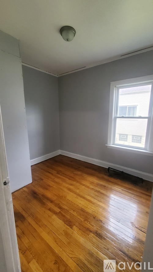 A room with wooden floors and a window.