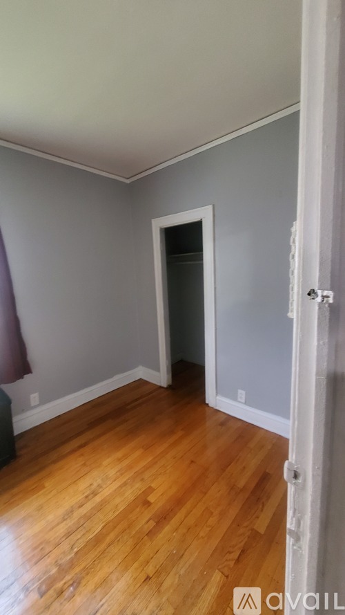 A room with wooden floors and a white door.