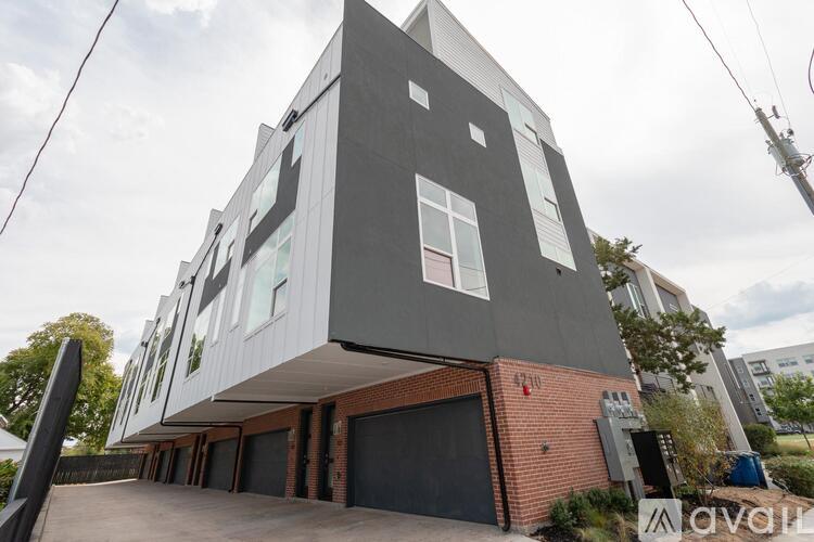 A modern two-story house with a garage on the ground floor.