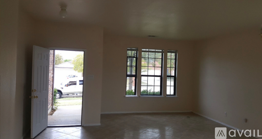 A room with a doorway leading to a patio.