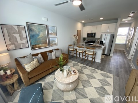 A living room with a brown sofa and a checkered floor.