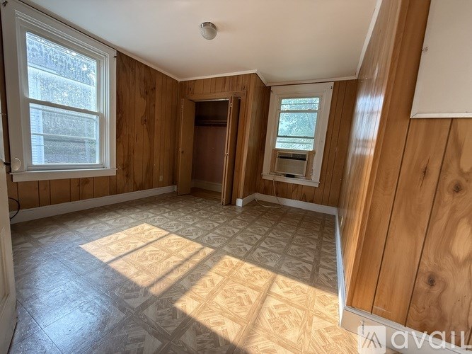 A room with wooden walls and a tiled floor.