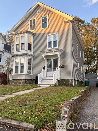 A two-story house with a front porch and a garage.
