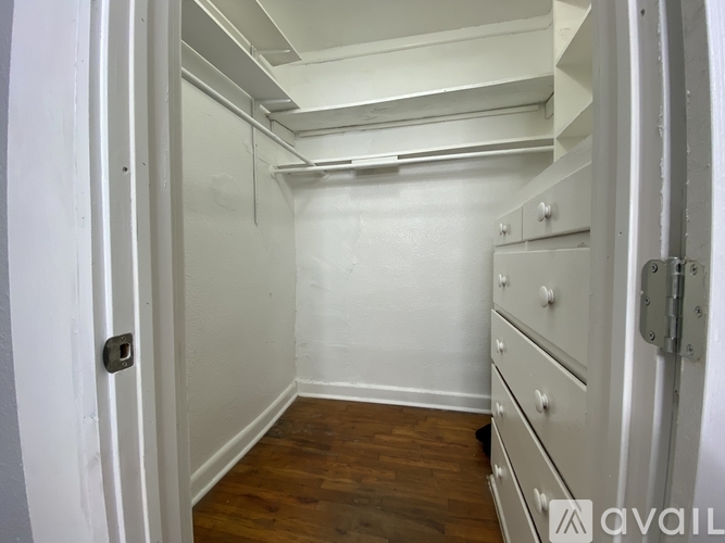 A white door with a handle and a lock is open.
