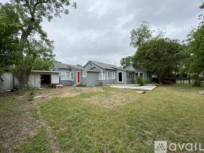 A row of houses with a grassy area in front.