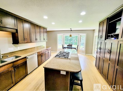 A kitchen with wooden cabinets and a granite countertop.