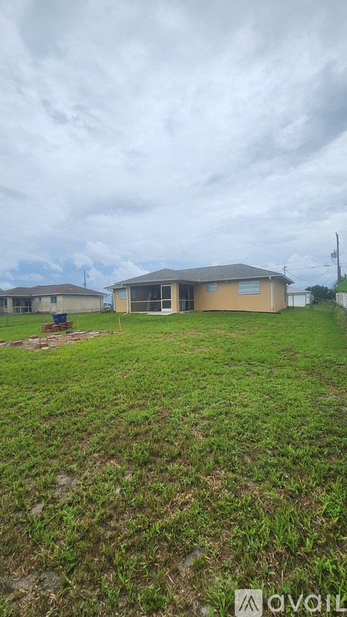 A grassy area with a house and a sign that says "available".