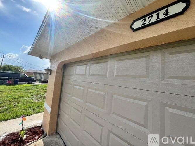 A house numbered 2714 with a white garage door.