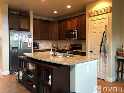 A kitchen with granite countertops and a sign that says "Groceries" above it.