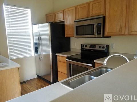A kitchen with wooden cabinets and stainless steel appliances.