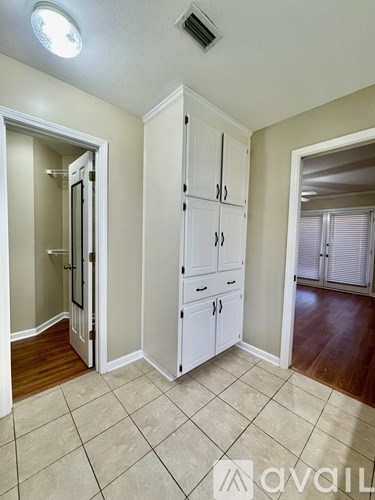 A room with a white cabinet and a tiled floor.