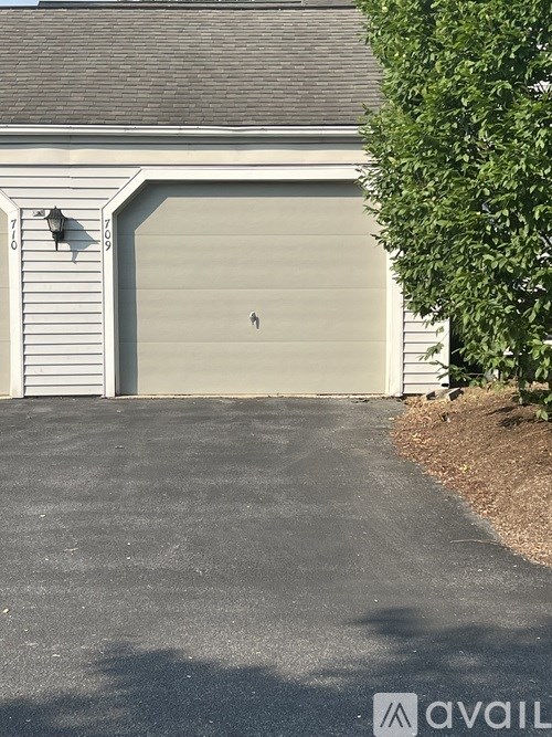 A white garage door with a small window in the center.