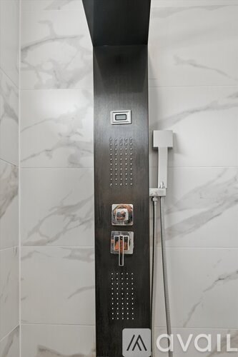 A shower with a hose attached to it.