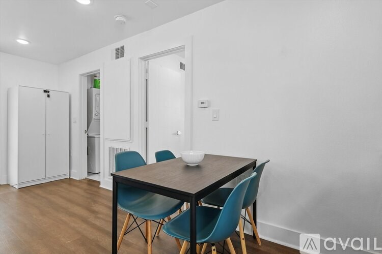 A dining room with a table and chairs.