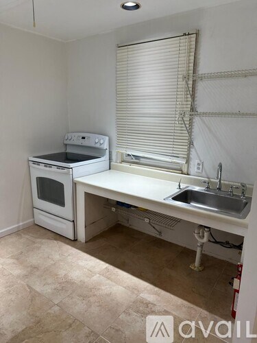 A small kitchen with a sink and a stove.