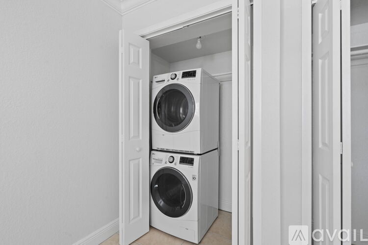 A stacked washer and dryer in a small space.