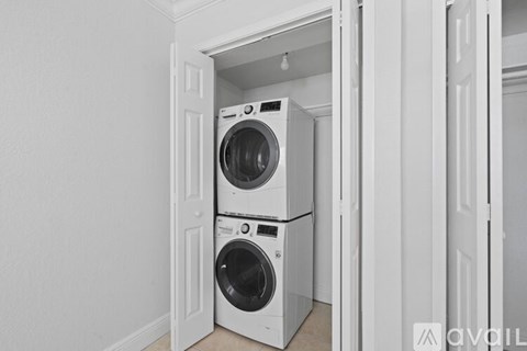 A stacked washer and dryer in a small space.